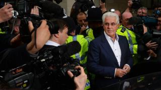 Photographers surround British publicist Max Clifford as he leaves Westminster Magistrates Court in 2013 where he entered not guilty pleas after being charged with 11 counts of indecent assault