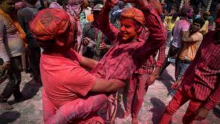People celebrate Holi, the spring festival of colours, during a gathering at a temple in Uttar Pradesh state in India