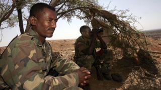 Ethiopian soldiers take advantage of the shade of a tree on 20 November 2005 on a hilltop outpost overlooking the northern Ethiopian town of Badme, in the Tigray region, towards the Temporary Security Zone and the Eritrean border.
