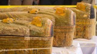 A photograph taken on October 19, 2019 shows sarchophagi displayed in front of Hatshepsut Temple in Egypt"s valley of the Kings in Luxor