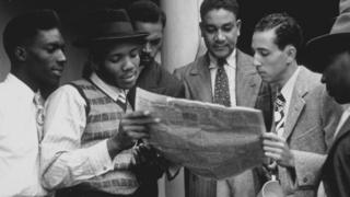 The Windrush passengers reading the paper in June 1948