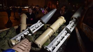 People look at wreckage of Russian missiles in Lviv, Ukraine on 31 December