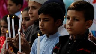 Pakistani school children light candles and pray to mark the second anniversary of terrorists attack on Army Public School attack in Peshawar, Pakistan, 16 December 2016