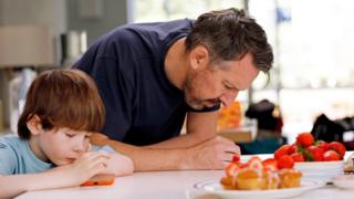 Concerned parent looking at mobile