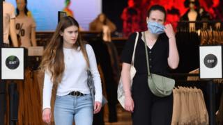 Shoppers leaving a clothing store in London