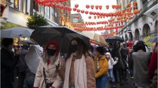 People wearing face masks in London's China town