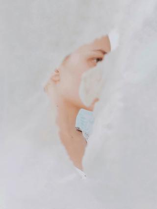 woman part-hidden in white cloth