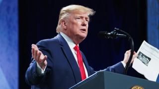 US President Donald Trump speaking at a podium