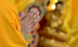 A Chinese Buddhist monk prays during a day of special prayers at the Quirino Grandstand in Manila on 9 August 2014