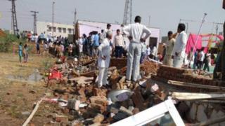The guests had taken shelter from heavy rain under a tin shack when a wall collapsed onto it in the storm.