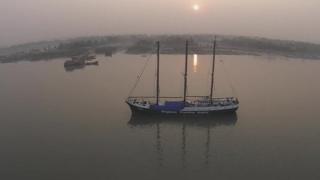An aerial shot of a ship at anchor