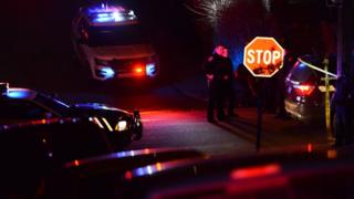 Police investigate the scene after a shooting in Wilkinsburg
