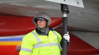 man filling aircraft with fuel