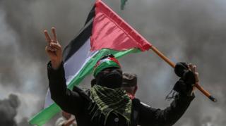 A Palestinian protester during clashes near the border with Israel in the east of Jabaliya in the northern Gaza Strip, 14 May 2018