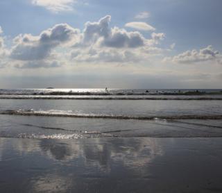Clouds reflected in waves
