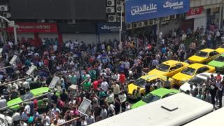 Iranian protesters gather outside mobile phone shop in Tehran on 25 June 2018