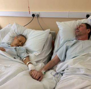 Mike Bennet, 57, and wife Julie, 50, from Irby in Wirral, holding hands in a hospice
