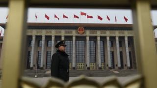 A Chinese soldier stands guard outside the Great Hall of the People as National People's Congress meetings continue inside in Beijing on 15 March 2016