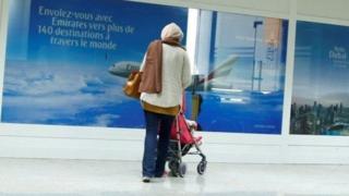 A women are seen in front of the Dubai airline Emirates office, at Tunis-Carthage International Airport in Tunis, Tunisia, December 25, 2017