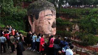 Tourists visit the Leshan Buddha in Sichuan province