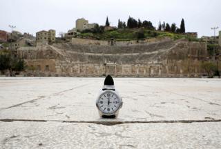 A watch showing the time at noon in front of the Roman amphitheatre in Amman, Jordan