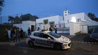 French police officers and people stand in front of the mosque of Bayonne on 28 October 2019, after two people were injured in a shooting