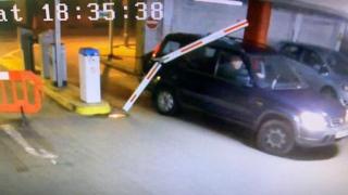 A car driving through a barrier