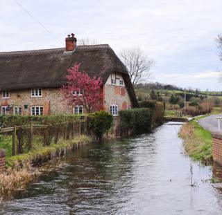 A river flowing by a house
