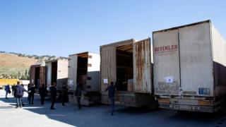 Trucks carrying humanitarian aid are seen at the Bab al Hawa border crossing