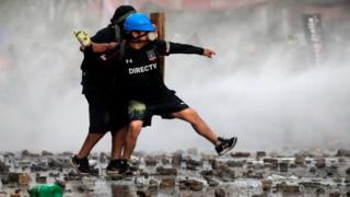 Demonstrators clash with riot police during a protest demanding greater social reform on 12 November, 2019.