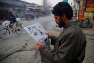 A man reading Kashmir Reader