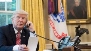 US President Donald Trump on telephone in the oval office
