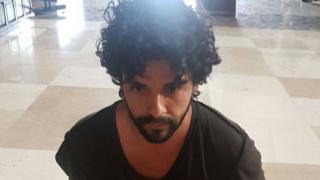 The suspect, kneeling on the cathedral floor, after his arrest