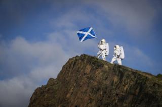 Actors Joy Maria Onotu (left) and Sarah Miele, stars of the Edinburgh Fringe show 'Valentina's Galaxy' take their first steps on what looks like a new planet but is in fact the Salisbury Crags in Holyrood Park above the city of Edinburgh, 15 August 2019.