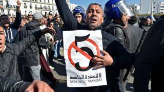 A protester holding a sign in Algiers