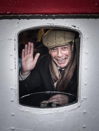 Brexit Party leader Nigel Farage looks out from a window on the Kestrel crabbing boat in Grimsby fish dock. PA Photo. Issue date: Wednesday December 11,