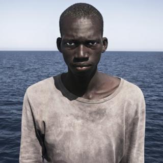 Amadou Sumaila in front of the sea moments after being rescued from a migrant boat