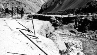 Damage from the flood wave at a power company camp near Huallanca, which is visible in background.