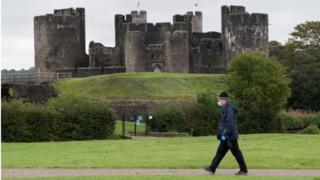 Man walks past Caerphilly castle