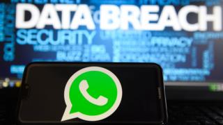 Tech In this photo illustration, the Whatsapp logos is seen on a Huawei smartphone with the word Data breach on a laptop monitor.