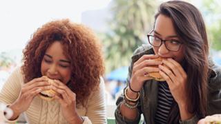 Girls eat hamburgers
