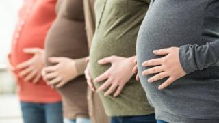 Row of pregnant women