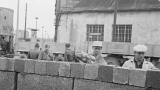East German workers building the Berlin wall in 1961.