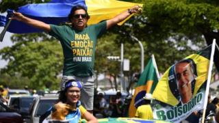 Proponents of Brazil's right-wing presidential candidate, Jair Bolsonaro, take part in a campaign rally in Brasilia on 6 October 2018.