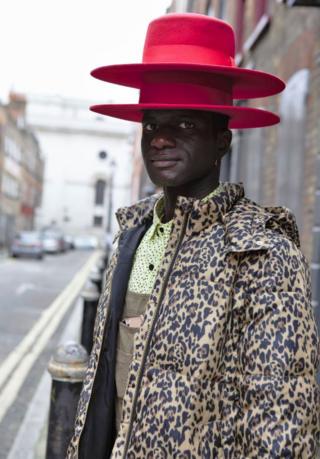 Man with two hats on top of each other