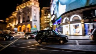 A London typical taxi is seen in Piccadilly Circus