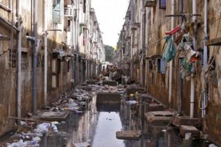 Municipal workers clear the debris in an alley after flood waters receded in Chennai, India, December 7, 2015