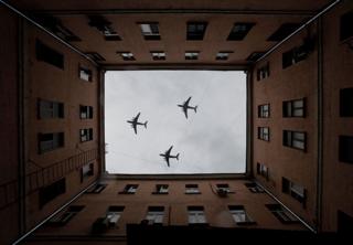 healthy fod for babies Three military aircraft fly over a building