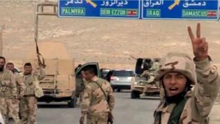 Forces loyal to Syria"s President Bashar al-Assad gesture as they advance into the historic city of Palmyra in this picture provided by SANA on March 24