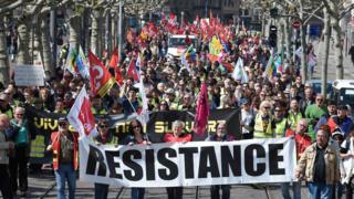Protesters hold a banner as they march during the annual May Day rally in Strasbourg